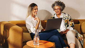 Two businesswomen looking at a laptop