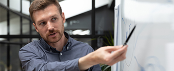 Picture of office worker presenting on the board