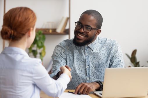 man shaking hand with woman