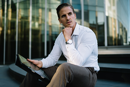 pensive-male-entrepreneur-digital-gadget-sitting