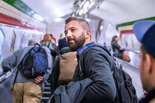 hipster-man-standing-escalator-london-subway
