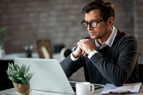 dedicated-entrepreneur-sitting-office-desk-reading