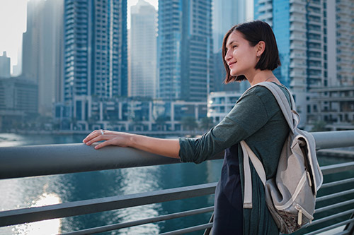 happy-young-female-traveler-big-city