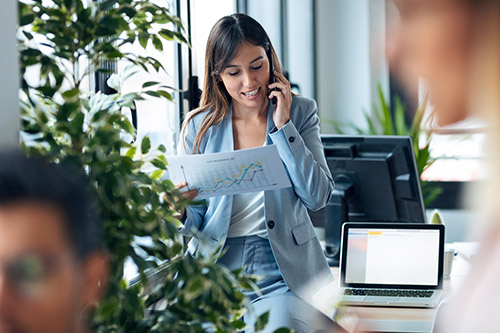 shot-smart-young-businesswoman-talking-mobile