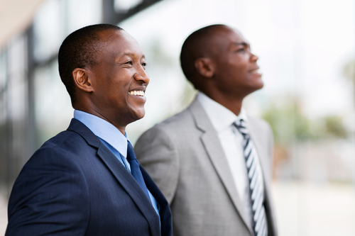 Two businessmen smiling