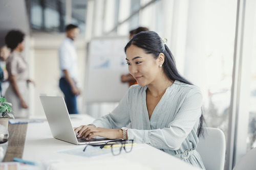woman typing on a laptop