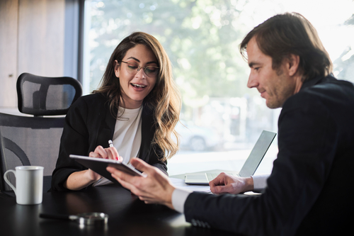 Two colleagues discussing a report