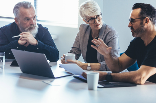 Three colleagues in an office meeting