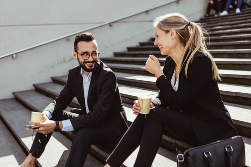 two businesspeople sitting on the stairs