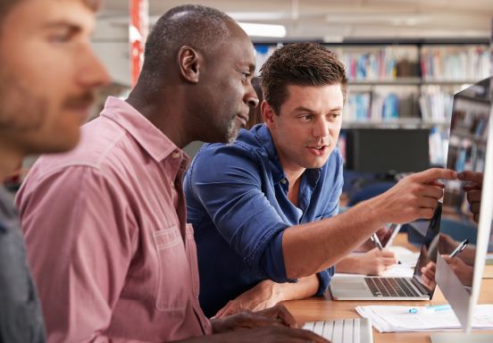 Men collaborating on a project while looking at a computer screen