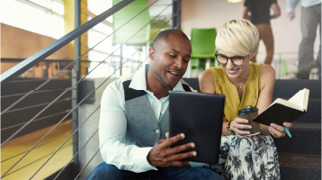 Two businesspeople looking at a report