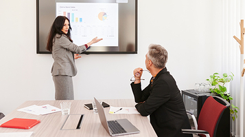 A businesswoman presenting data to a client